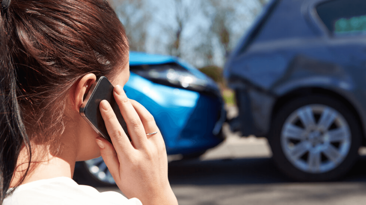 A woman on the phone after a car crash